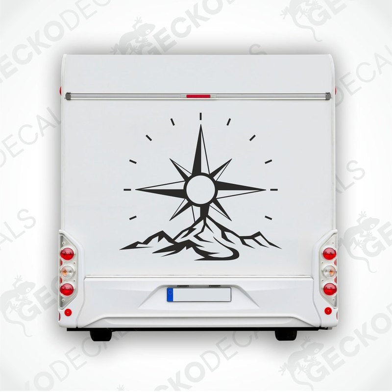 A die cut decal featuring a compass design with mountains, intended for use on a caravan.
