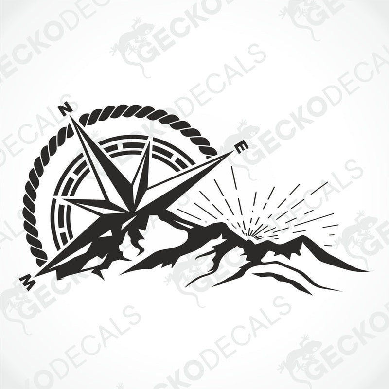 A black and white die cut decal of a compass with mountains and a sun in the center, displayed on a white vehicle.