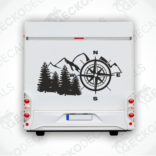 A white vehicle decal featuring a black compass design with mountains and a tree backdrop.