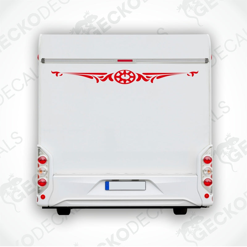 White caravan with a red and black compass design decal on the rear side.