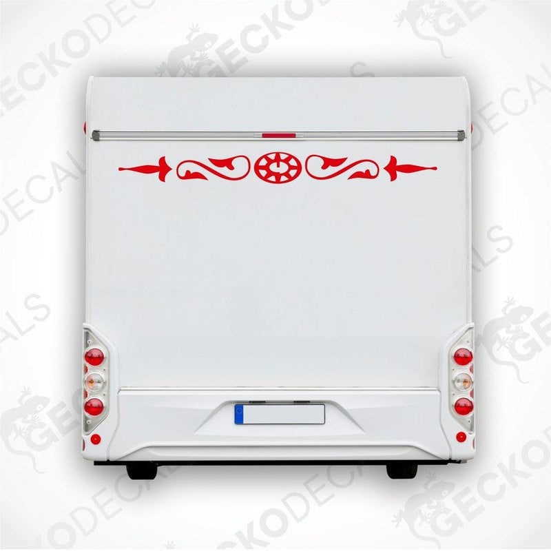 White caravan with a red and black compass design decal on the rear side.