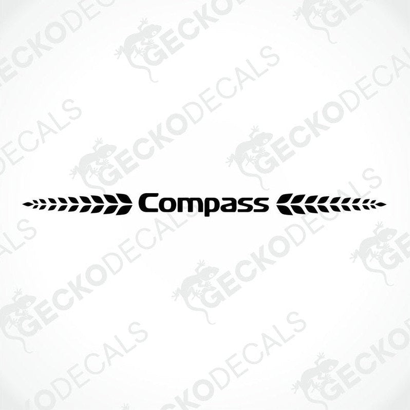 A white Compass caravan with a die cut sticker of the Compass logo on the rear side.