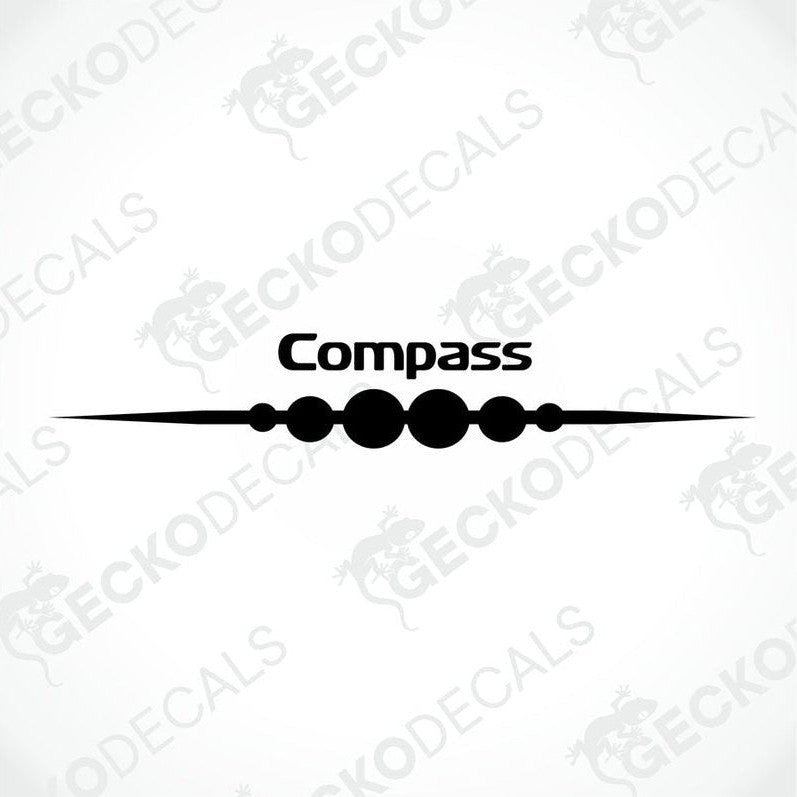 A white compass decal with the brand name written in red, placed on the rear side of a caravan.