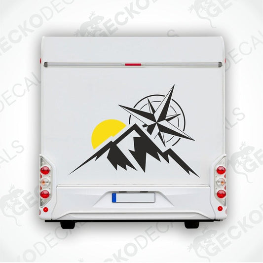A white vehicle decal with a compass design, mountains, and a sun motif.
