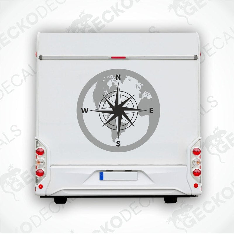 Laminated vinyl compass world map sticker applied to white RV tailgate