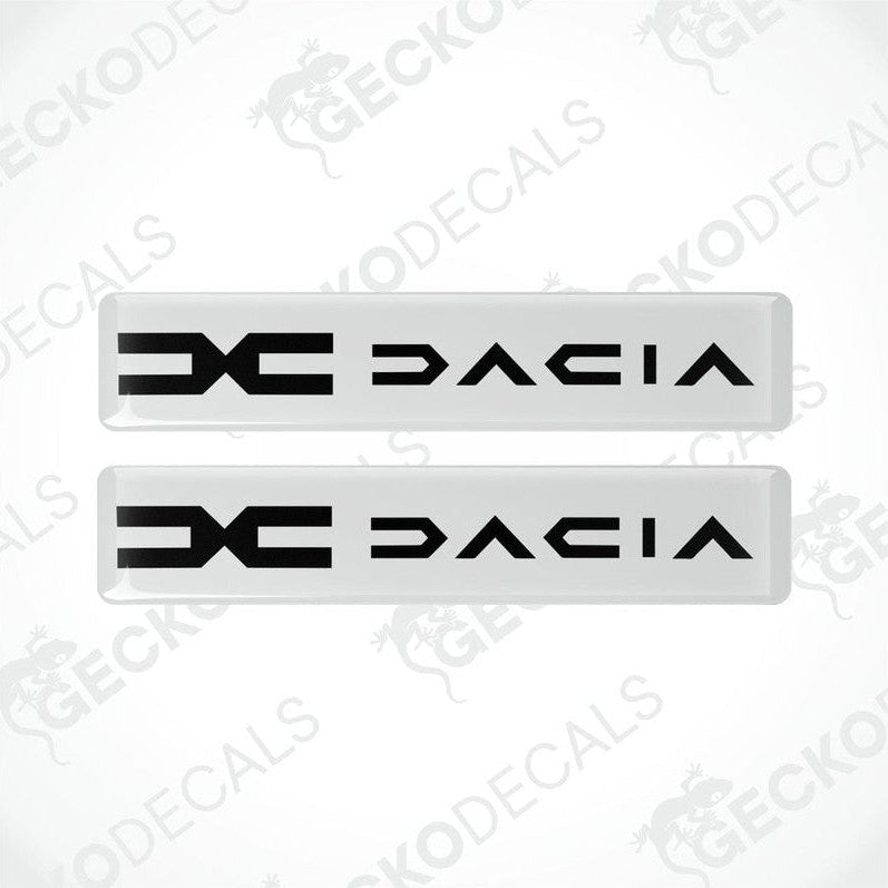 A pair of white vinyl decals with the word 'DACIA' written in black.