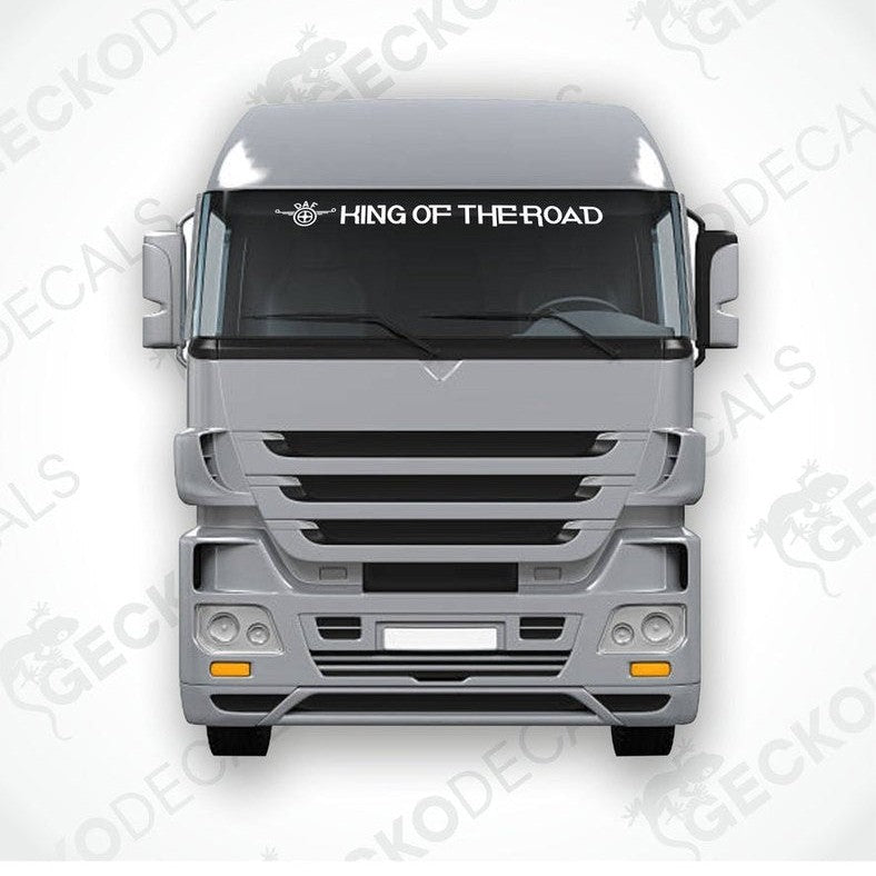 A die cut decal with the phrase 'KING OF THE ROAD' printed on it, positioned on the front windshield of a gray truck.