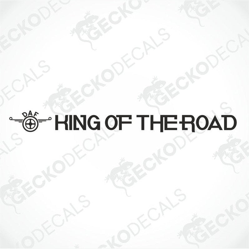 A die cut decal with the phrase 'KING OF THE ROAD' printed on it, positioned on the front windshield of a gray truck.