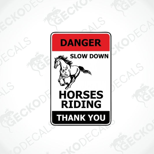 A decal with a black horse and rider on it, with the text 'DANGER: SLOW DOWN HORSES RIDING. THANK YOU' in white and red.