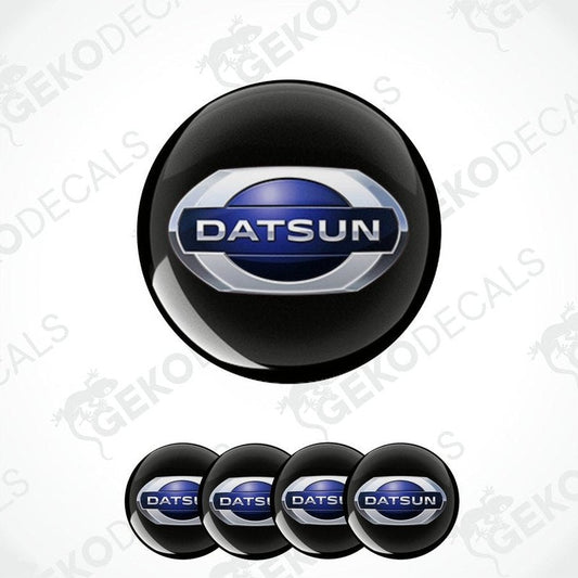 A set of four black vinyl decals with the Datsun logo in blue and white.