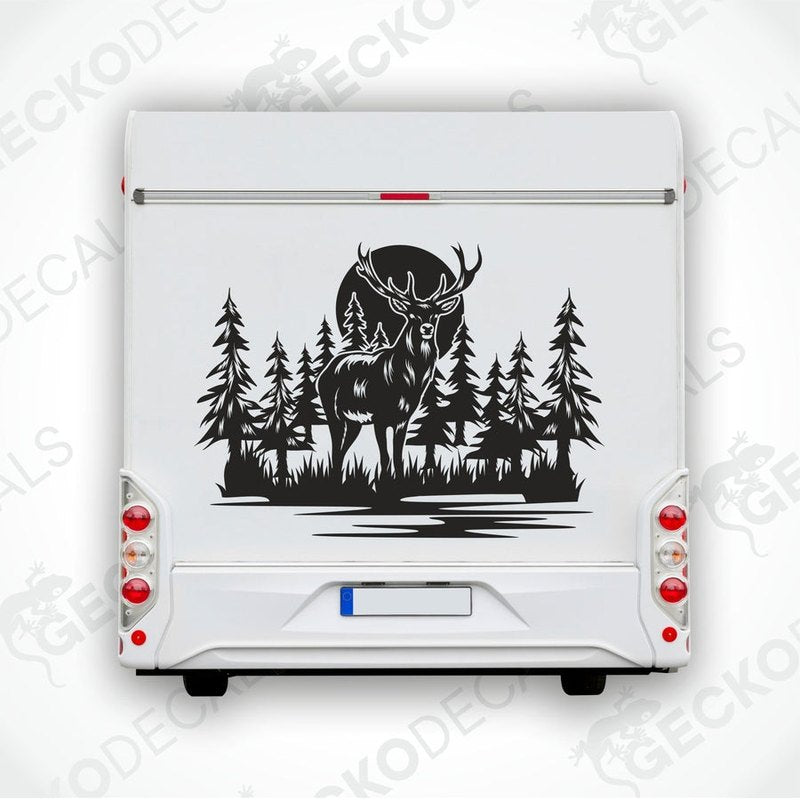 A die cut decal of a deer in a forest setting, intended for use on vehicles or other surfaces, displayed on a white background.