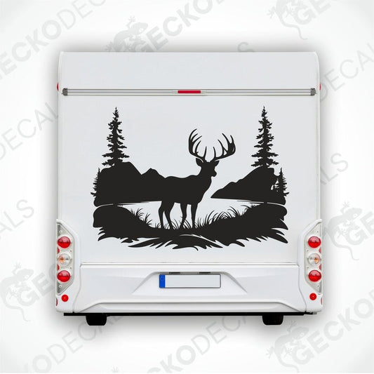 A black decal of a deer in a natural setting with trees and a sky background, positioned on the side of a white vehicle.