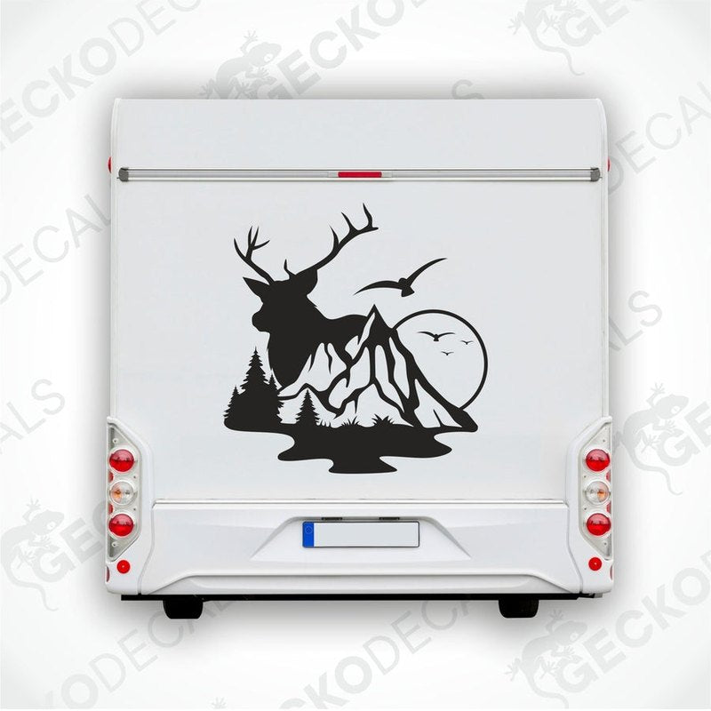 A die cut decal of a deer with mountains in the background, intended for use on vehicles or other surfaces.