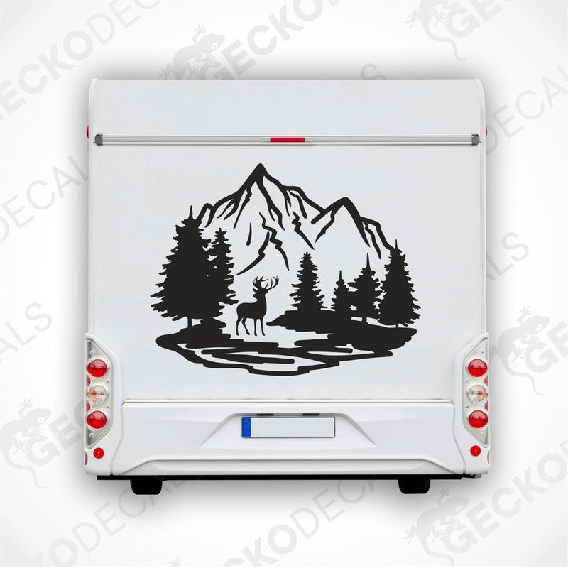 A decal of a mountain with trees and a silhouette of a deer on it.