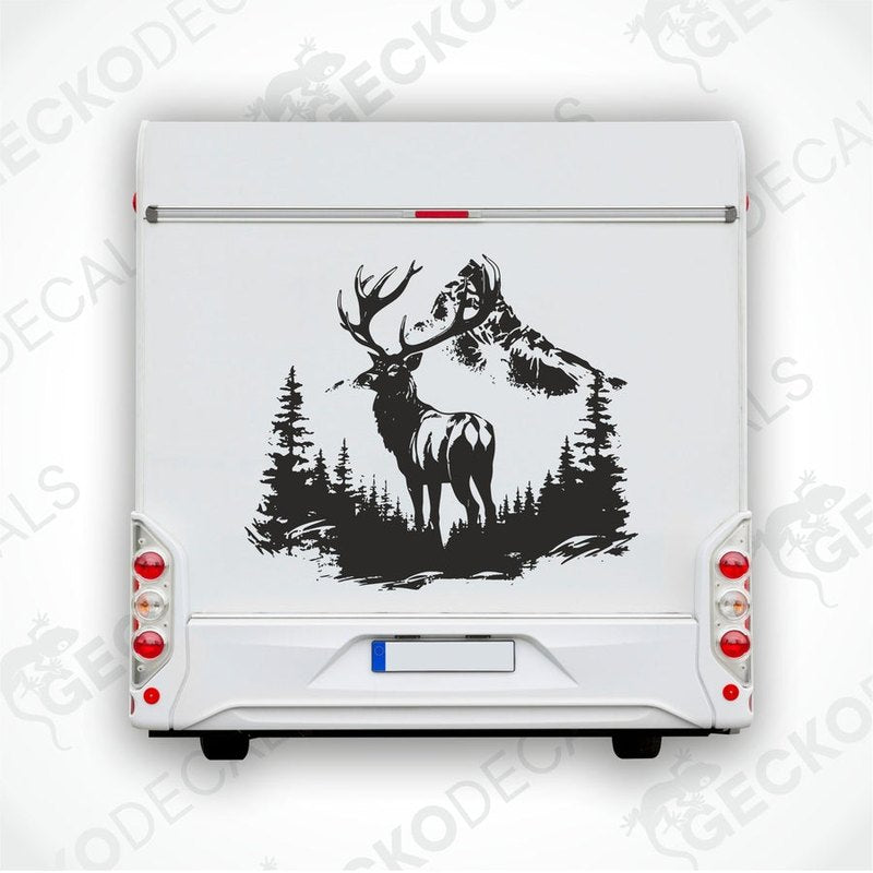 A decal of a deer with a full rack of antlers and a mountain range in the background, positioned on the side of a white vehicle.