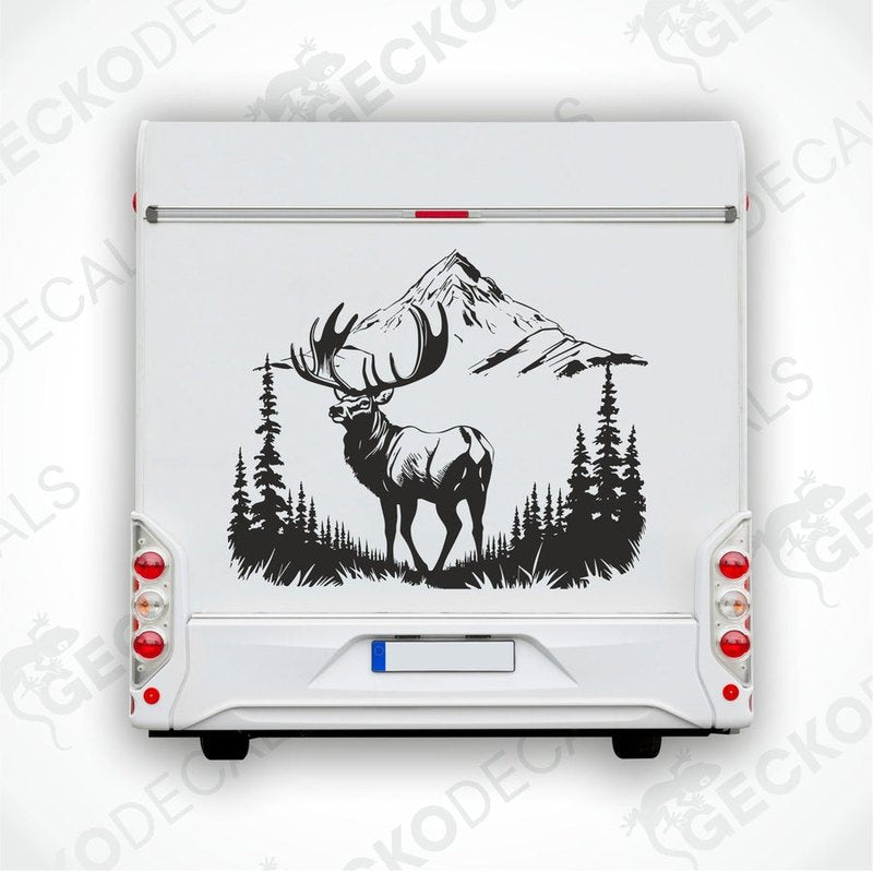 A decal of a deer in a mountainous landscape, positioned on the side of a white vehicle.