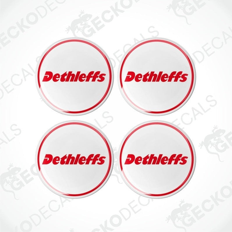 A set of four white, red, and black colored vinyl decals with the Dethleffs brand logo.