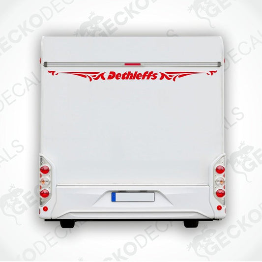 A white caravan with a red 'Dethleffs' decal on its rear side.