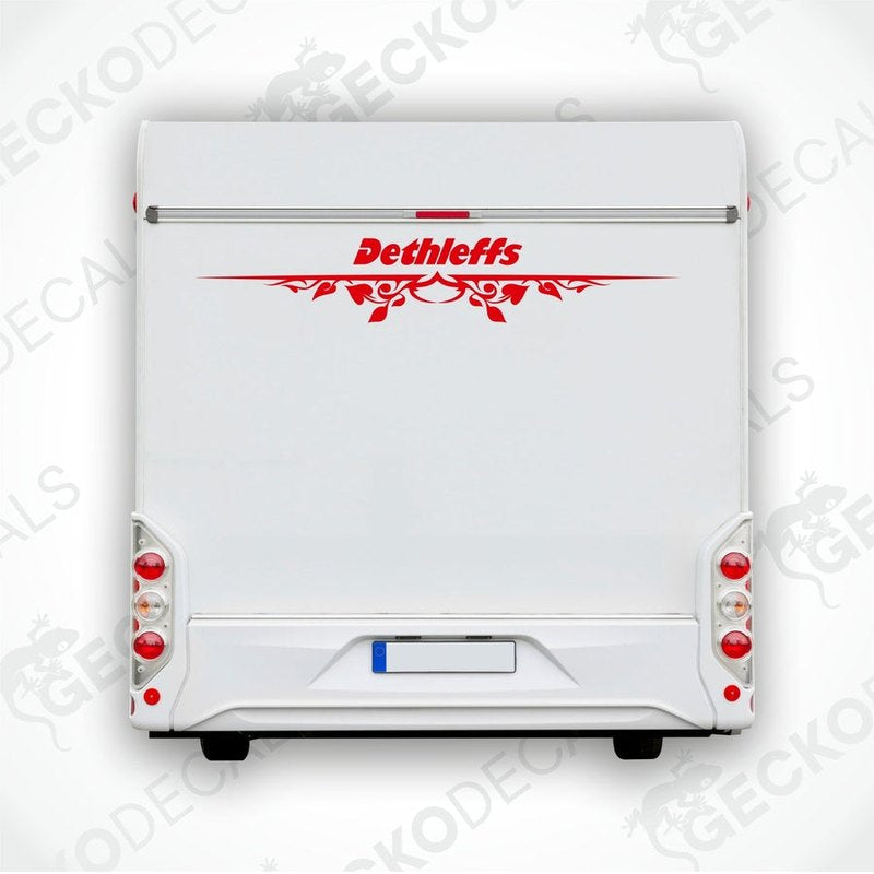 A white Dethleffs caravan with a red and black logo decal on the rear side.