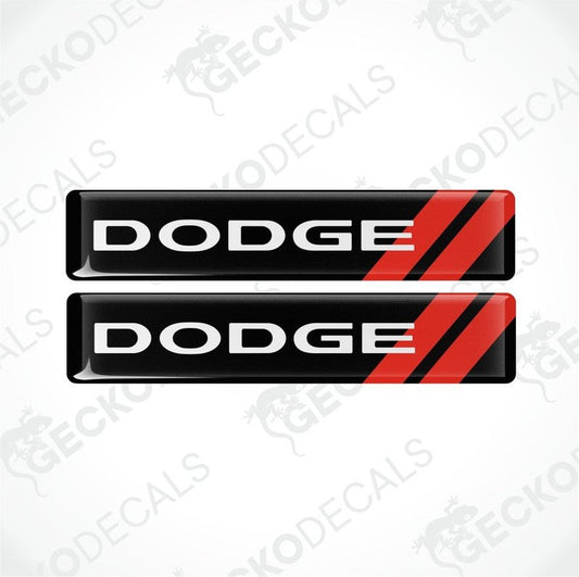 Two black vinyl decals with red stripes and the text 'DODGE' displayed prominently on each decal.