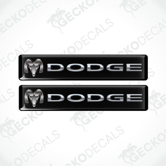 Two black vinyl stickers with the word 'Dodge' printed on them.