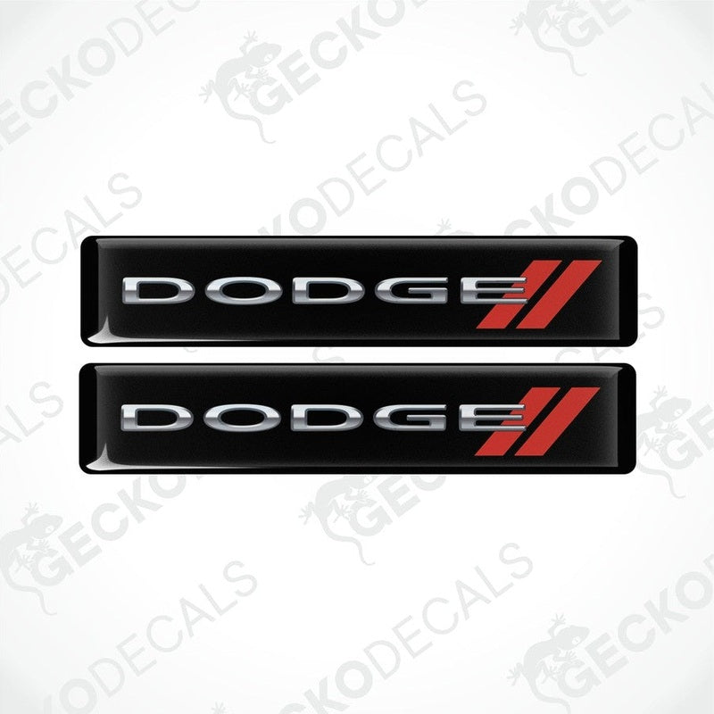 Two black vinyl stickers with the word 'DODGE' and a red and silver logo design on them.