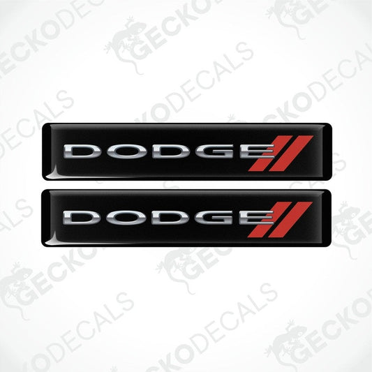 Two black vinyl stickers with the word 'DODGE' and a red and silver logo design on them.