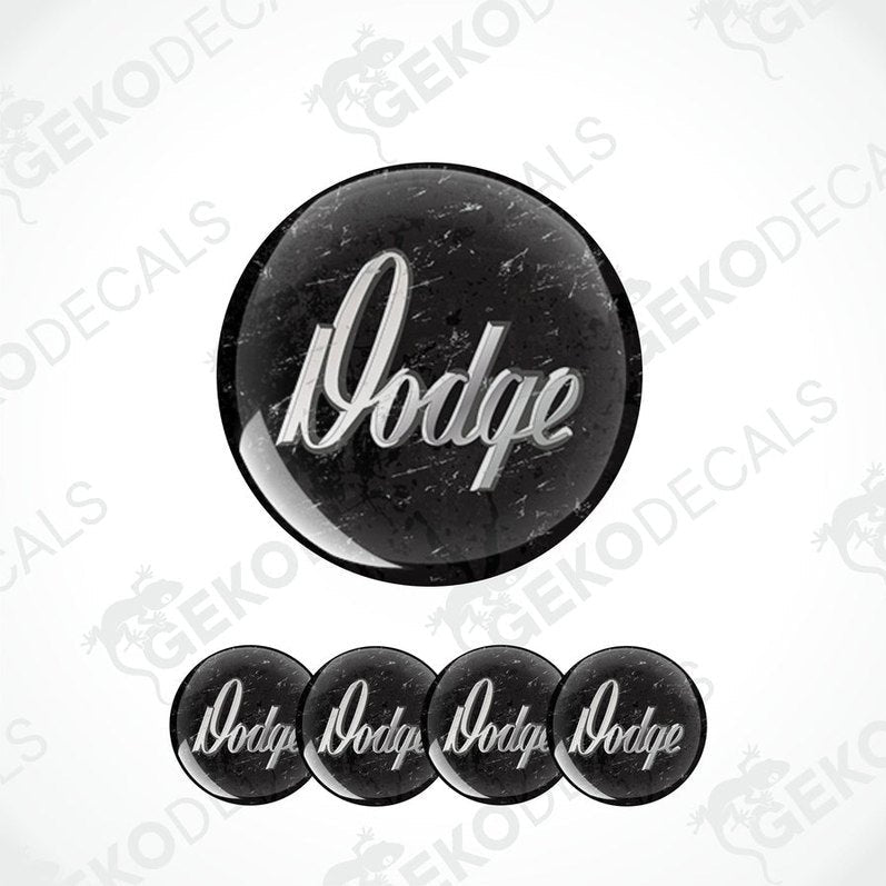 A set of four black vinyl stickers with the word 'DODGE' printed in white.