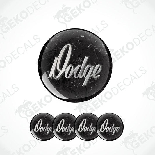 A set of four black vinyl stickers with the word 'DODGE' printed in white.