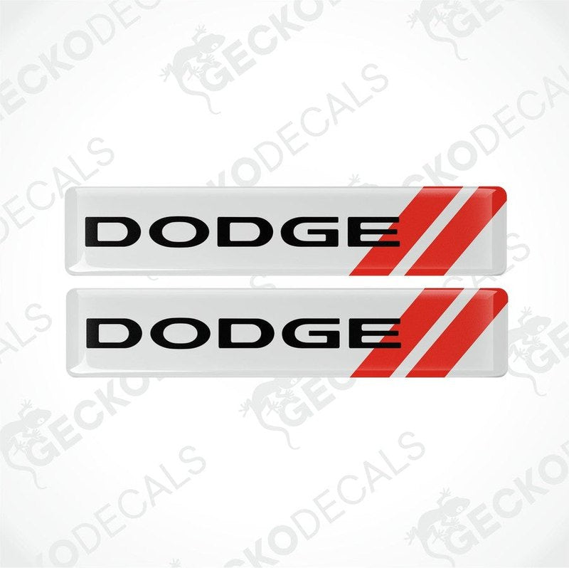 Two white vinyl decals with red stripes and the text 'DODGE' displayed prominently on each decal.