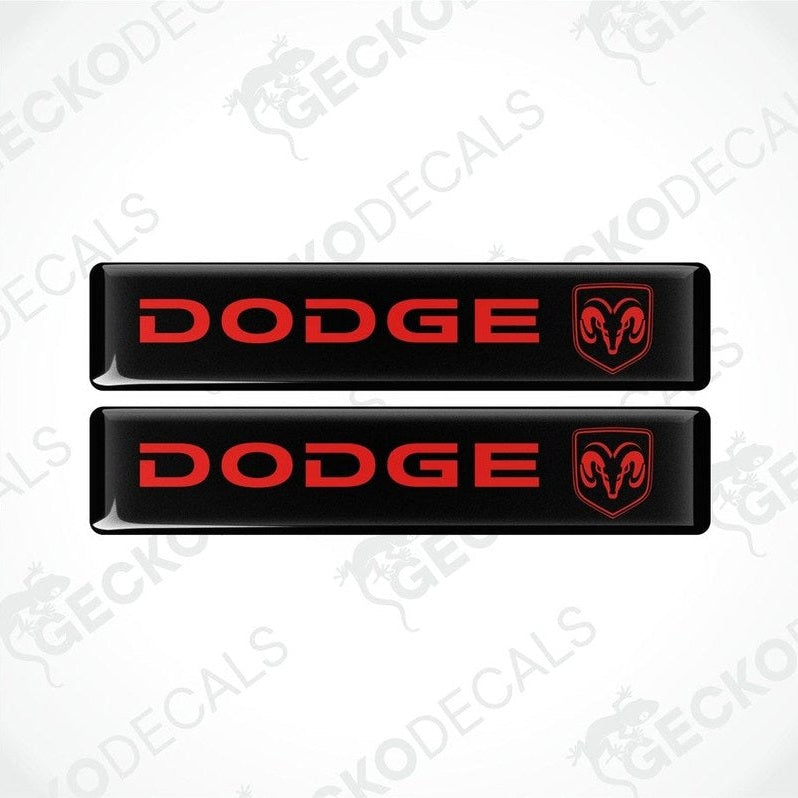 Two black vinyl decals with the Dodge brand logo in red.
