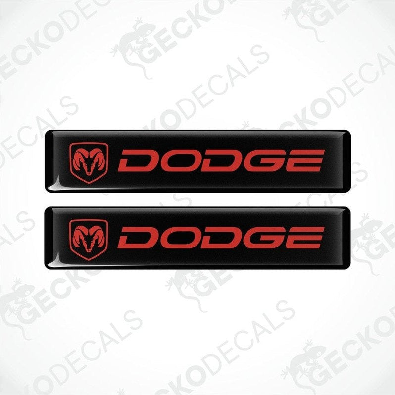 Two black vinyl decals with the Dodge logo in red.