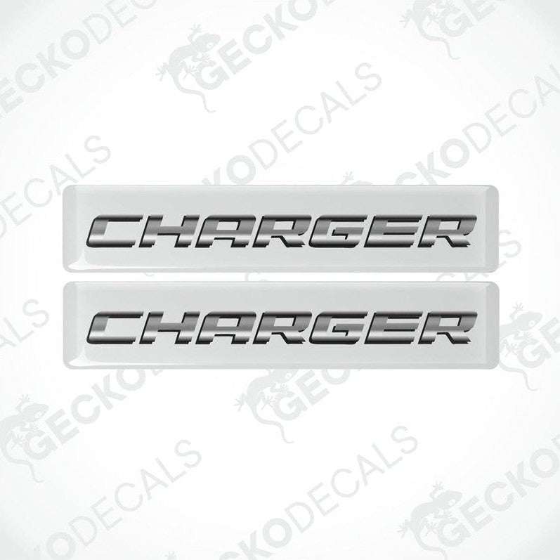 Two white vinyl decals with the word 'CHARGER' written in black letters.