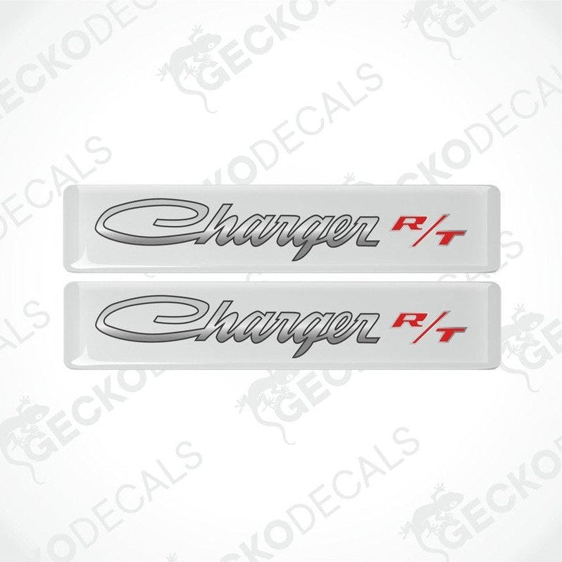 Two white vinyl decals with the text 'Charger R/T' on them, intended for use as car stickers.