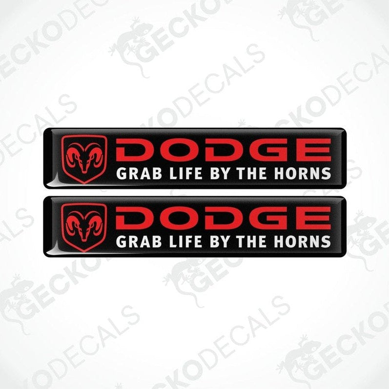Two black, red, and white vinyl decals with the text 'DODGE' and 'GRAB LIFE BY THE HORNS' on them.