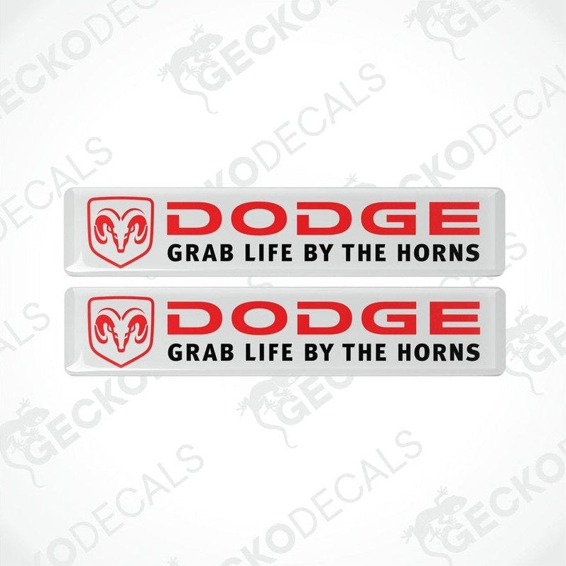 Two white, red, and black vinyl decals with the text 'DODGE' and 'GRAB LIFE BY THE HORNS' on them.