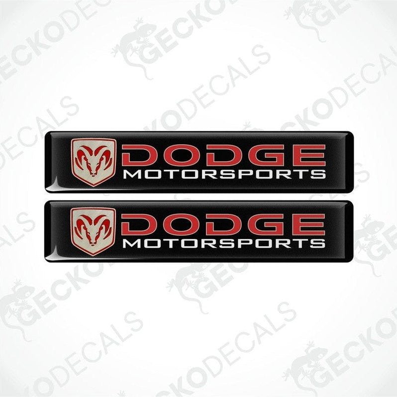 Two black vinyl stickers with a red and white Dodge Motorsports logo.