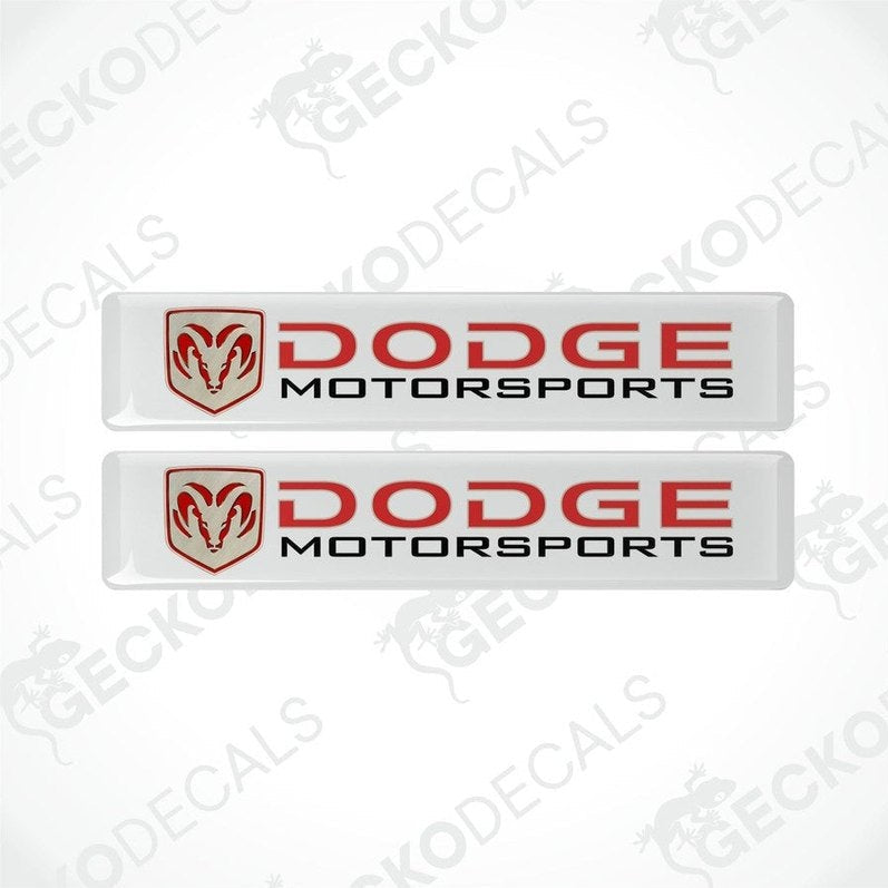 Two white vinyl stickers with a red and black Dodge Motorsports logo.