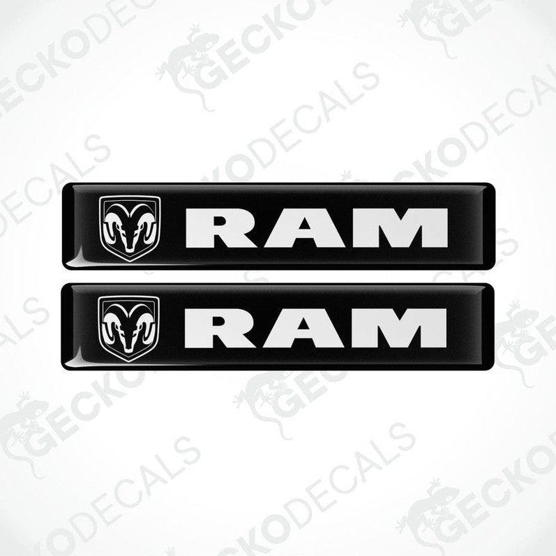 Two black vinyl decals with the RAM logo on them, intended for use as car stickers.