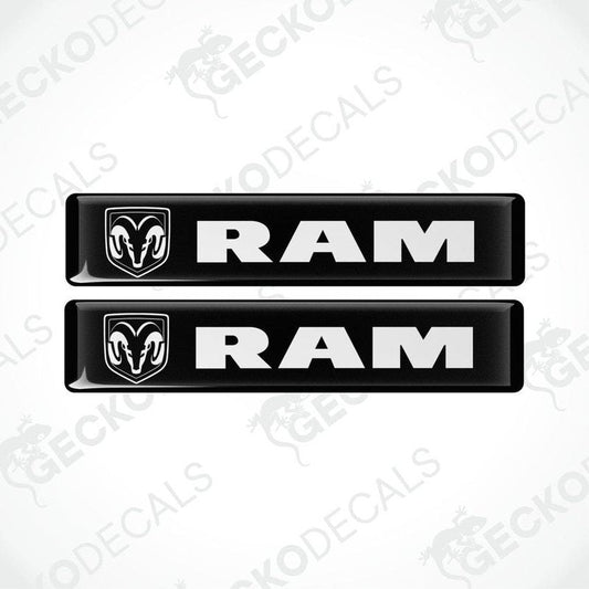 Two black vinyl decals with the RAM logo on them, intended for use as car stickers.