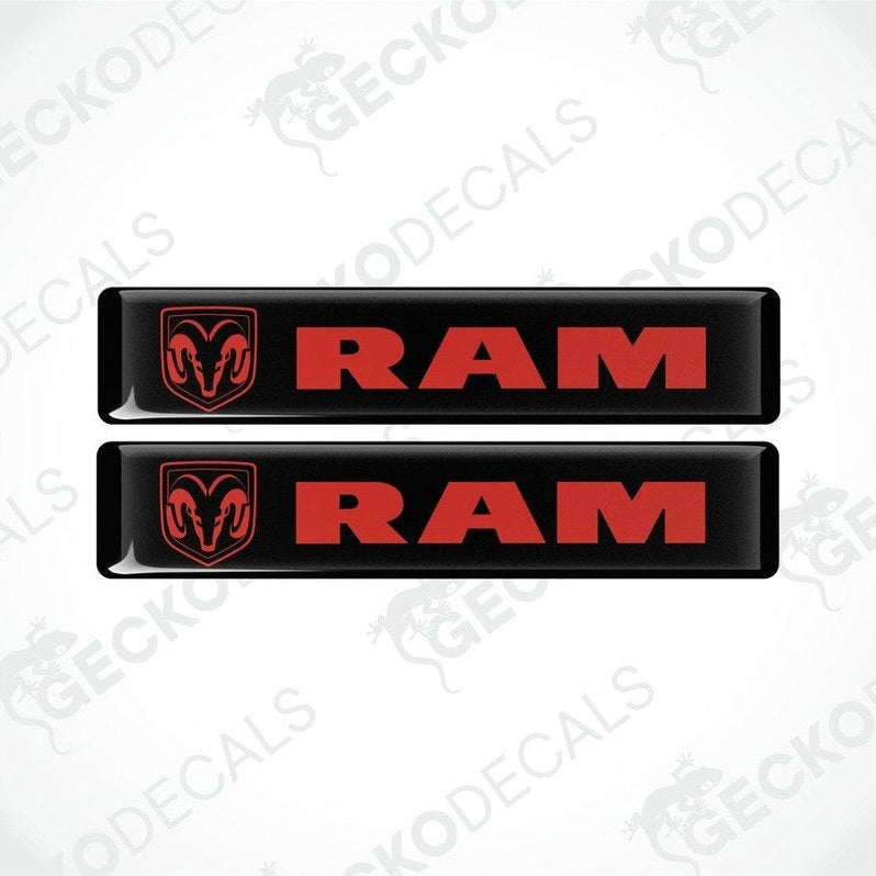 Two black vinyl decals with the RAM logo on them, intended for use as car stickers.