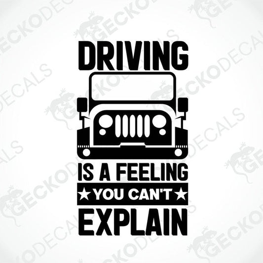 A black die cut sticker with the text 'DRIVING IS A FEELING YOU CAN'T EXPLAIN' and a graphic of a truck. The sticker has a white background and the text and truck illustration are in black.