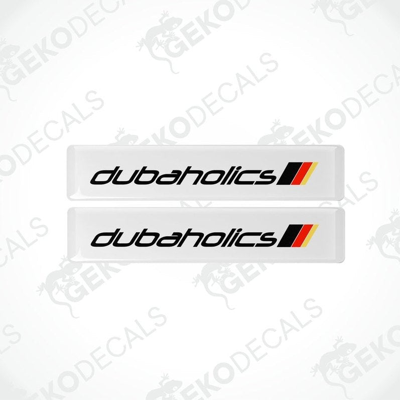 Two withe decals with red and black text that reads 'DUBAHOLICS'