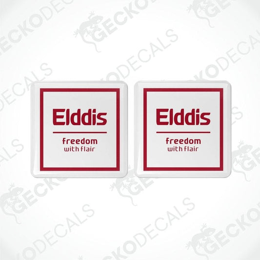Two white vinyl stickers with red and black text, including the word 'ELDDIS' and the slogan 'Freedom with Flair'. There is a graphic of a caravan on the stickers.