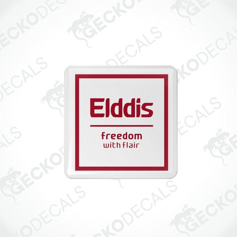 Two white vinyl stickers with red and black text, including the word 'ELDDIS' and the slogan 'Freedom with Flair'. There is a graphic of a caravan on the stickers.