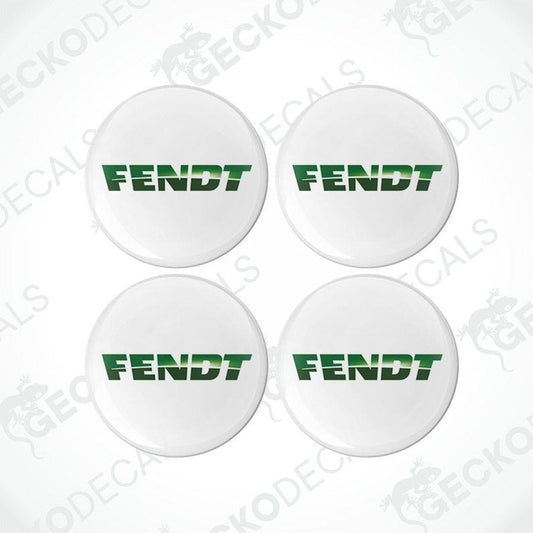 A set of four white round decals with the green text 'FENDT' on them, arranged in a square formation.