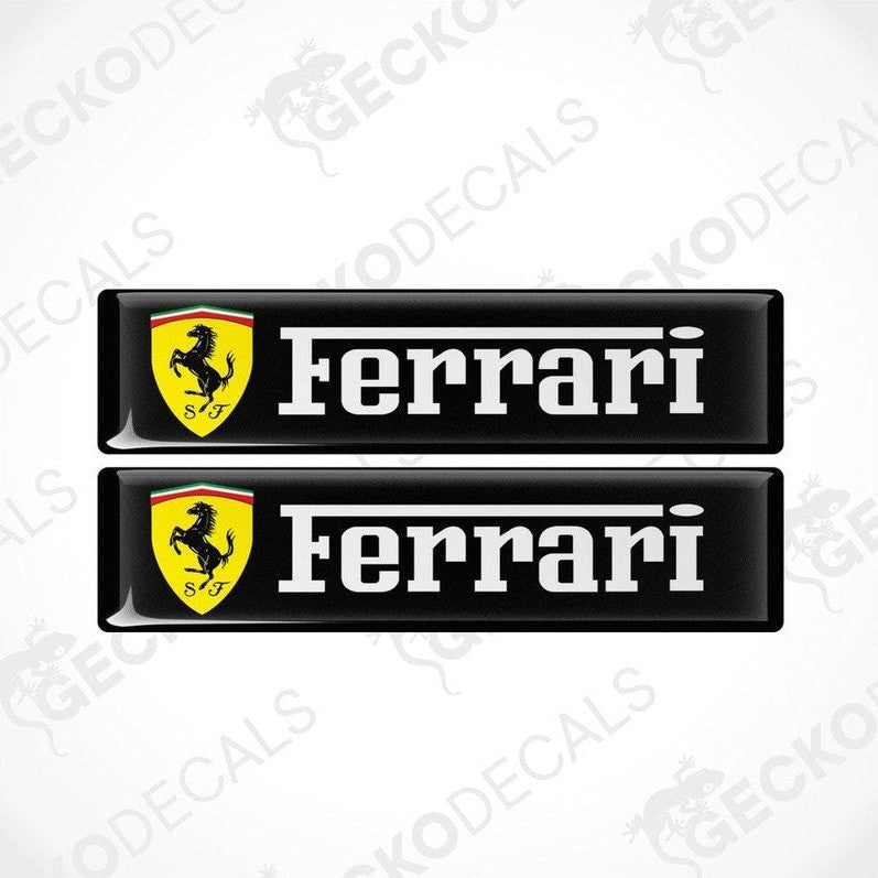 Two black, yellow, and white Ferrari car decals with the Ferrari logo and name.