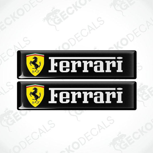 Two black, yellow, and white Ferrari car decals with the Ferrari logo and name.