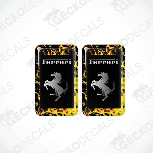 Two yellow, black, and red vinyl stickers with the word 'FERRARI' and a horse logo.