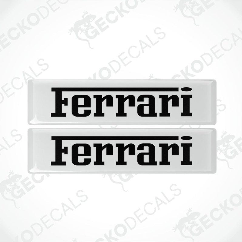 Two withe vinyl stickers with the FERRARI logo in black text.